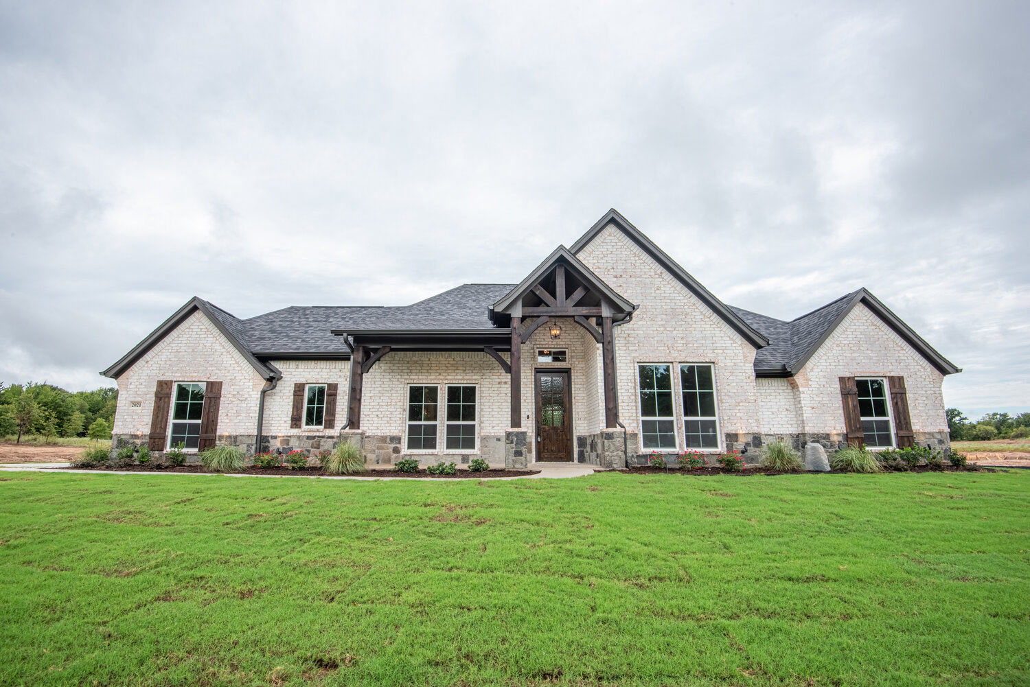 Custom home elevation with shingle roof, LBK project